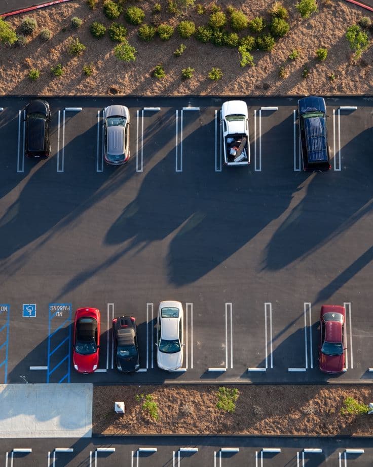 Aerial view of an organized parking lot with vehicles in marked stalls